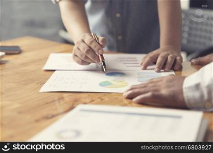 woman's hand holding pen working with business document for working concept, selective focus and vintage tone