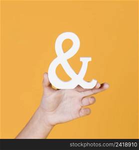 woman s hand holding sign yellow background