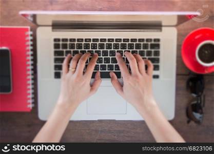 Woman's hand typing keyboard of laptop, stock photo