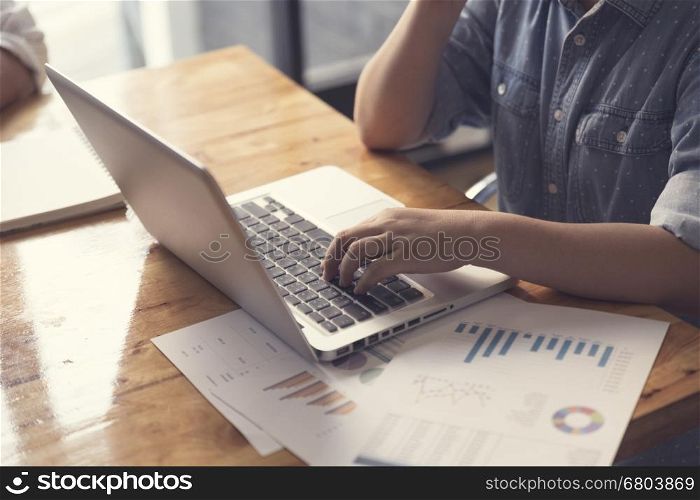 woman's hand with laptop computer notebook, selective focus and vintage tone