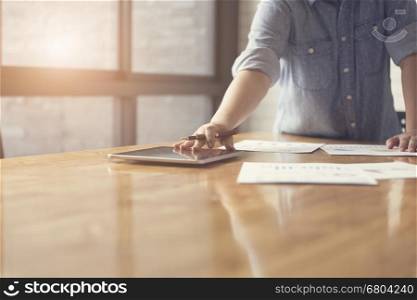 woman's hand working with business document and tablet for working concept, selective focus and vintage tone