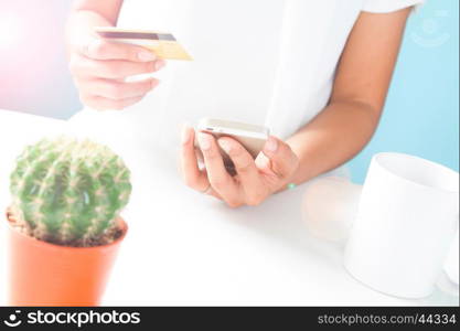 Woman's hands holding mobile phone and credit card. Online shopping