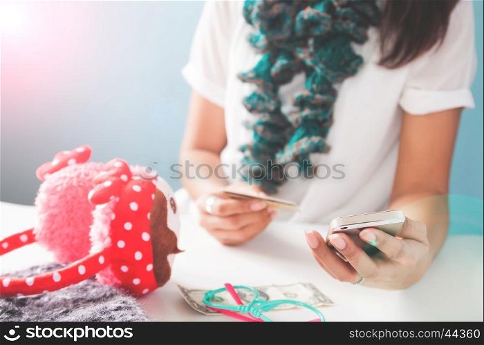Woman's hands holding mobile phone and credit card. Online shopping
