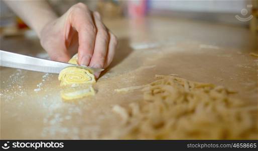 Woman's hands knead dough pasta