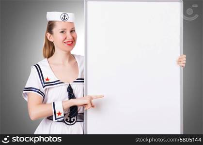 Woman sailor with blank board on white