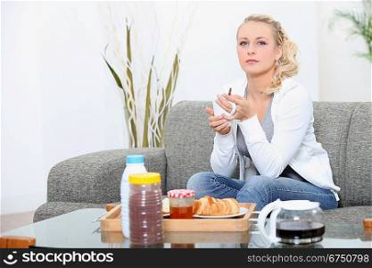 Woman sat at home eating breakfast