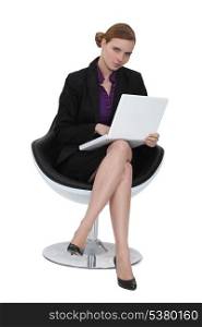 Woman sat in designer chair