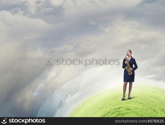 Woman saxophonist. Young woman in suit with saxophone in hands