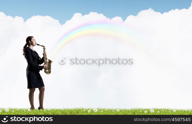 Woman saxophonist. Young woman in suit with saxophone in hands