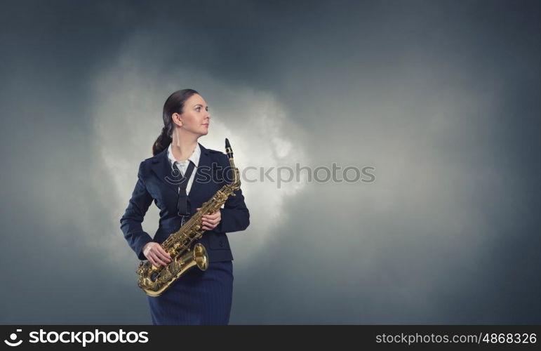 Woman saxophonist. Young woman in suit with saxophone in hands