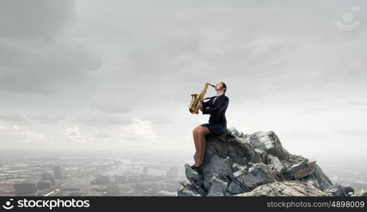 Woman saxophonist. Young woman in suit with saxophone in hands