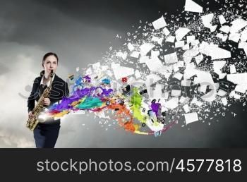 Woman saxophonist. Young woman playing saxophone and colorful splashes coming out