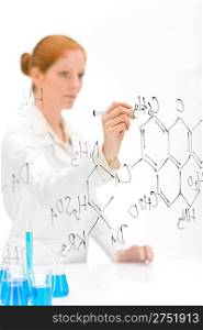 Woman scientist in laboratory write chemical formula with test bue and beaker