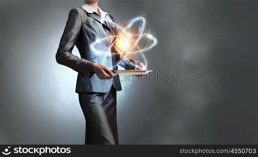 Woman scientist presenting atom research concept. Close up of businesswoman holding glowing atom in hands