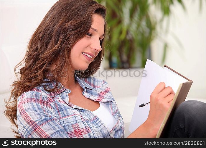 Woman scoring in notebook