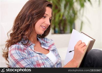 Woman scoring in notebook
