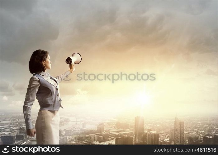 Woman scream in lodspeaker. Young businesswoman in suit proclaiming something in megaphone
