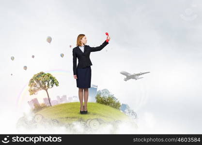 Woman scream in red receiver. Angry businesswoman screaming loudly into red phone handset