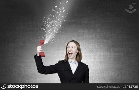 Woman scream in red receiver. Young businesswoman with red phone receiver in hands