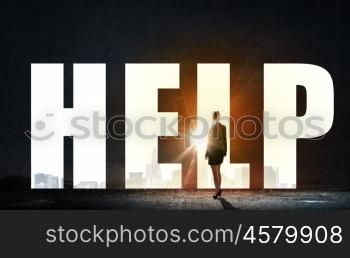 Woman searching for help. Back view of businesswoman standing in light word help