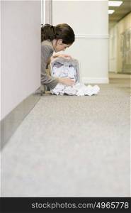 Woman searching in waste paper