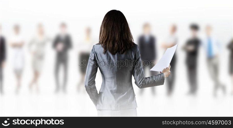 Woman secretary. Back view of businesswoman holding papers in hands