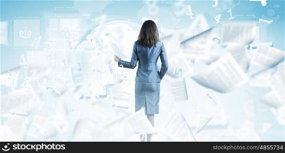 Woman secretary. Back view of businesswoman holding papers in hands