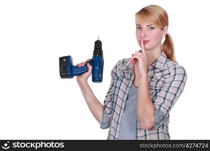 Woman secretly holding a drill
