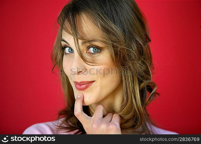 Woman seductively holding finger to chin