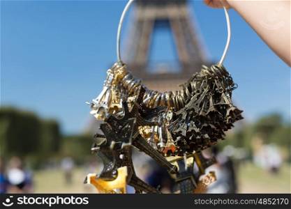 Woman selling small Eiffel Towers in the gardens of the Eiffel Tower, the main attraction in Paris, France