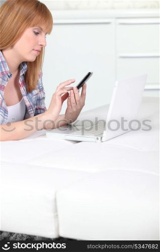 Woman sending message with mobile telephone