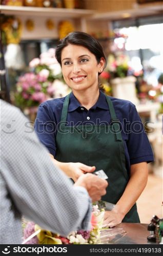 Woman serving customer in florist