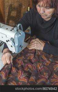 Woman sewing on a sewing machine.