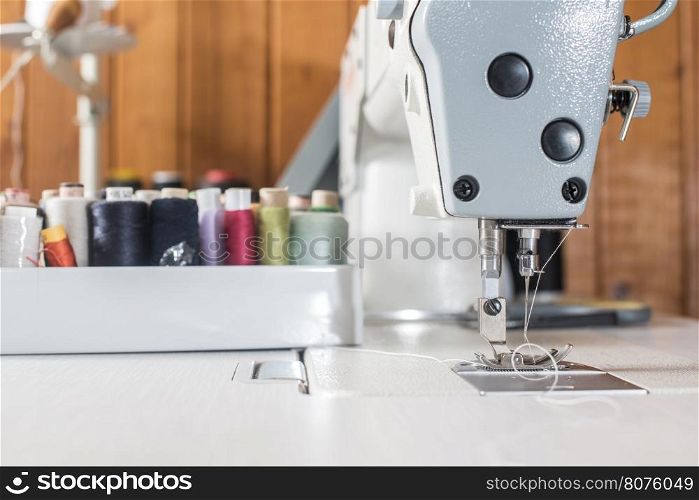 Woman sewing on a sewing machine. Close up