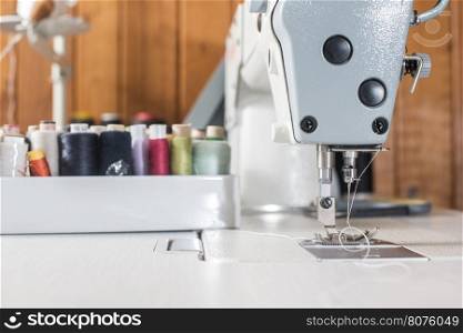 Woman sewing on a sewing machine. Close up