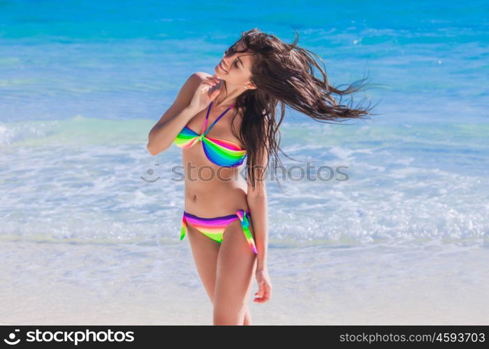 Woman shaking hair on beach. Woman shaking hair in bikini on beach