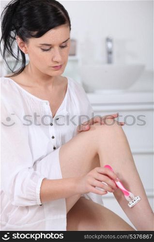 Woman shaving legs