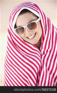 Woman Sheltering From Sun On Beach Holiday