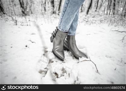 Woman shoes in the snow, glam silver leather boots