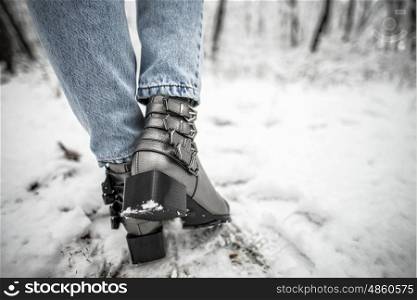 Woman shoes in the snow, glam silver leather boots