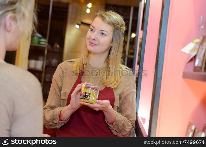 woman shopping and store assistant showing the best product