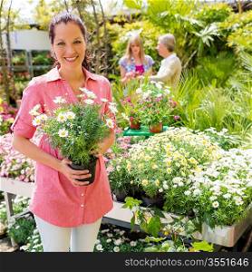 Woman shopping at flower shop green house garden centre
