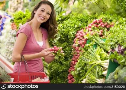 Woman shopping for beets at a grocery store