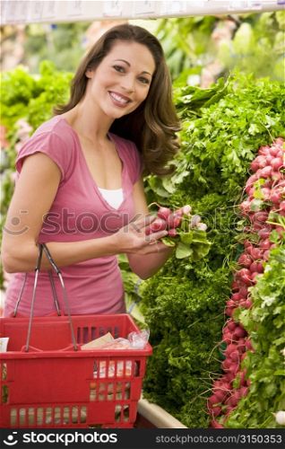 Woman shopping for beets at a grocery store