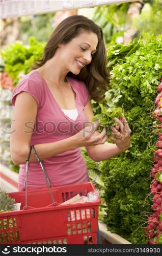 Woman shopping for herbs at a grocery store