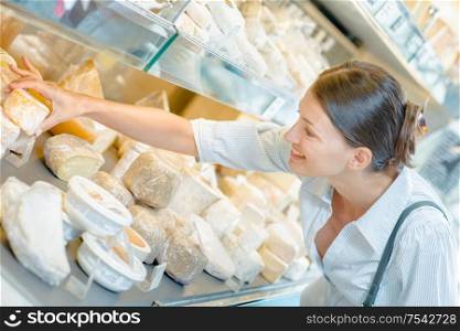 Woman shopping for some cheese