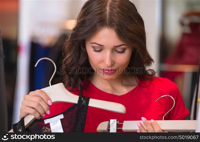 Woman shopping in an clothes store trying on new clothes