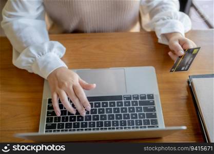 Woman shopping on laptop holding credit card for Internet online e-commerce shopping spending money Online shopping Mobile phone laptop technology 