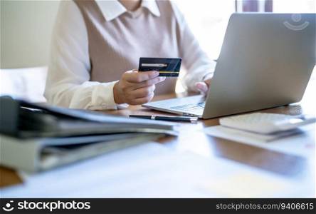 Woman shopping on laptop holding credit card for Internet online e-commerce shopping spending money Online shopping Mobile phone laptop technology 
