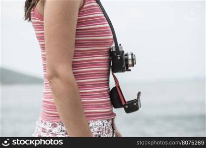 Woman shot with vintage camera on the beach.